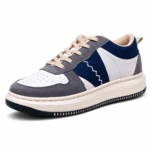 Three-quarter angle view of Zodack low-top sneaker in white perforated leather with grey and navy suede overlays, zigzag side embroidery, and beige laces