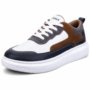 Three-quarter angle view of Zodack low-top sneaker in white leather with dark navy mudguard, cognac brown and grey suede accents, and a thick white cupsole